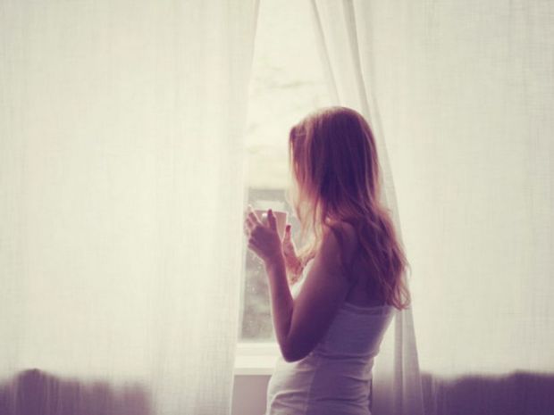 Young-girl-looking-through-window